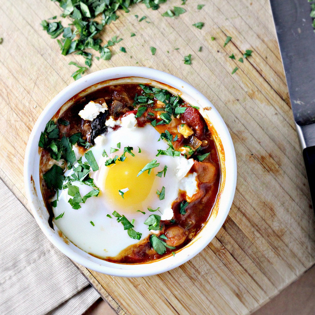 poached eggs in tomato sauce with chickpeas, feta and swiss chard