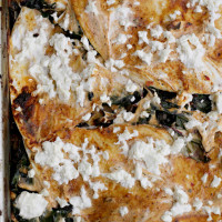 layered pasilla tortilla casserole with black beans, mushrooms and chard