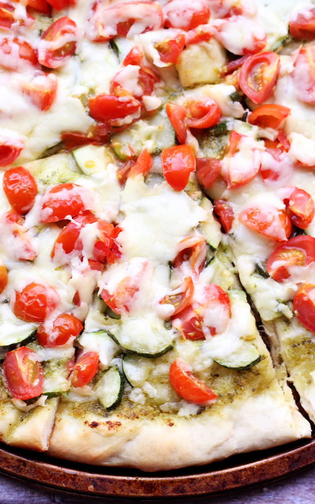 cherry tomato, zucchini, and pesto pizza