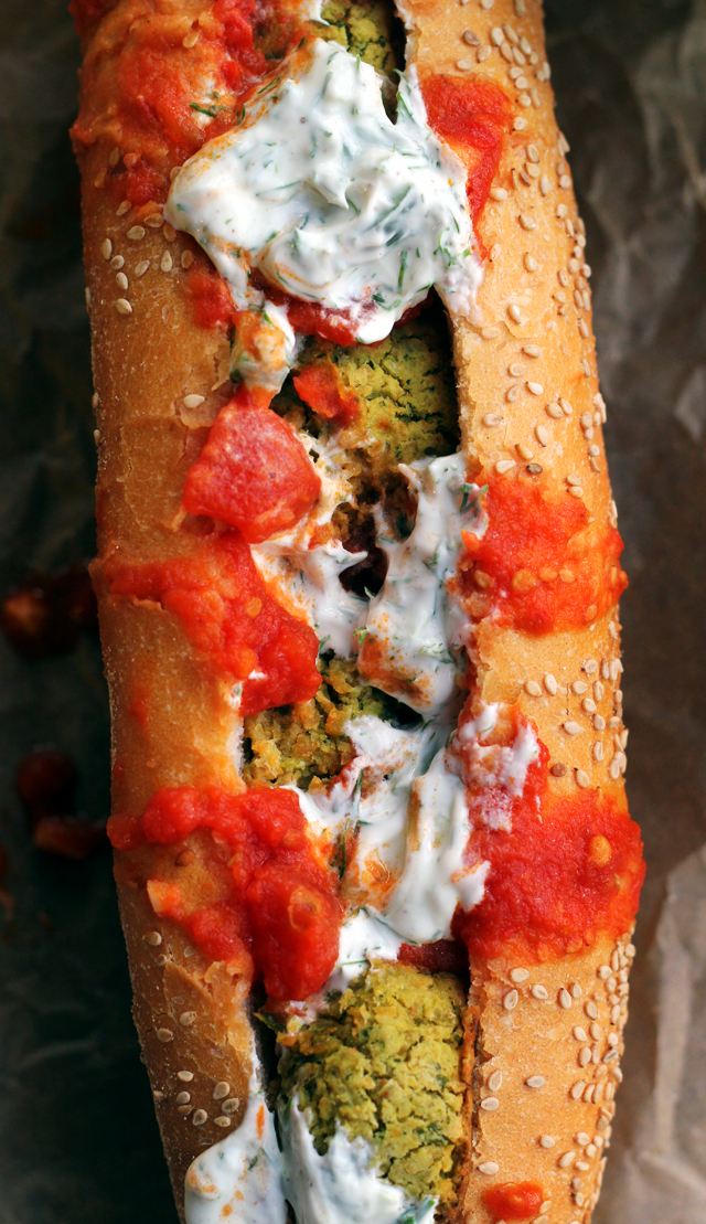 baked falafel hoagies with harissa tomato sauce and tzatziki