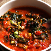 tomato soup with brown butter, kale, and pistachios
