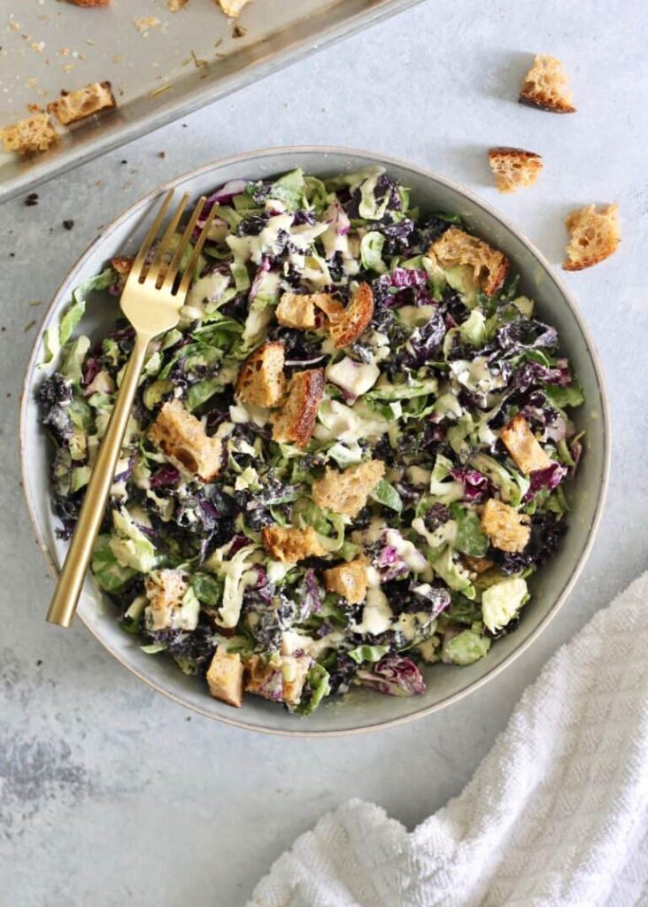 A bowl of  Kale and Caesar salad