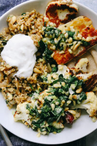 Roasted Cauliflower and Halloumi Bowls with Dates and Freekeh Pilaf