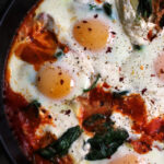 sicilian baked eggs with artichokes, burrata, spinach, and spicy tomato sauce