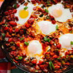 Cajun Eggs in Purgatory with Cheddar-Scallion Grits